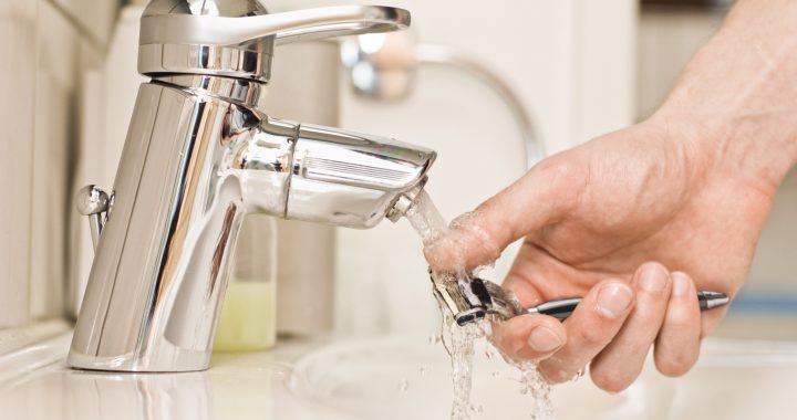 Person demonstrating how to clean a razor effectively