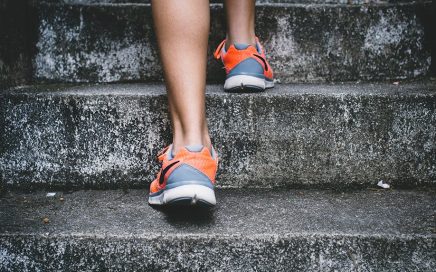 Person wearing trainers running up steps