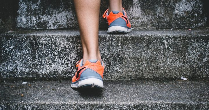 Person wearing trainers running up steps